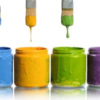 Paintbrushes Dripping into Paint Containers